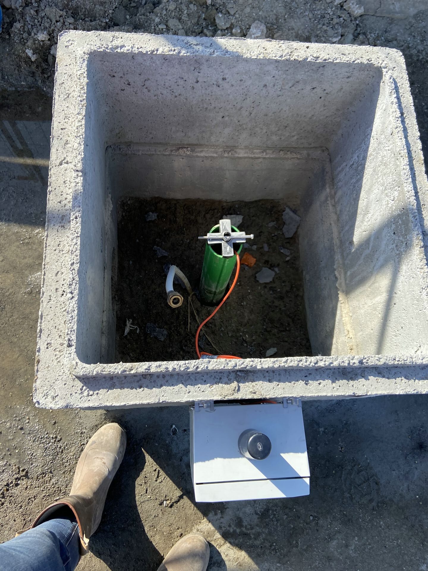 In-Place-Inclinometer sensor chain installed into the casing and supported onto the Top Cap, The sensors are daisy chained and a network cable is shown comming out of the rop of the casing going to a data logger,