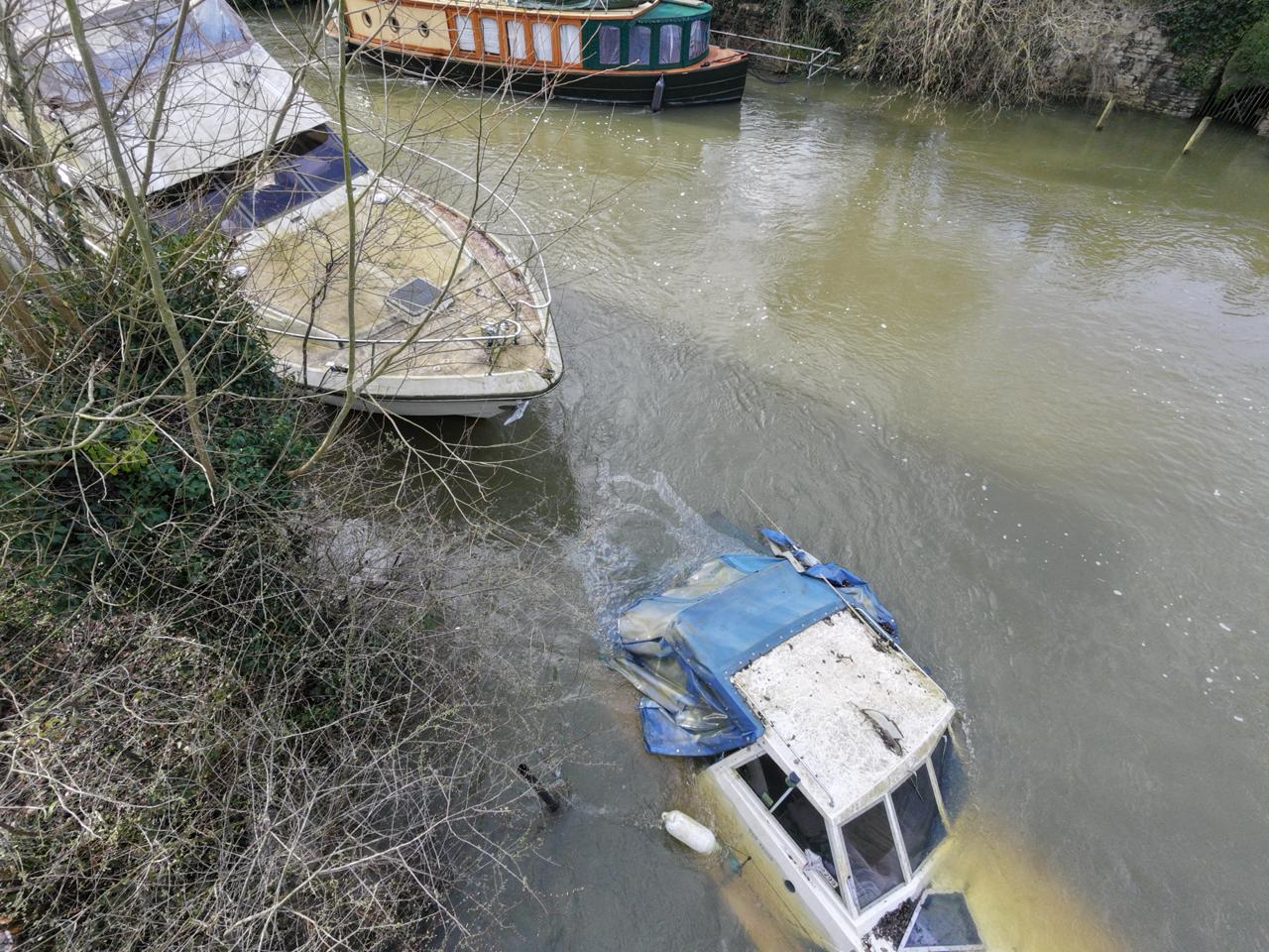 Paul Goddard's photograph shows a sunken boat surrounded by an oil spill in the River Thames at Abingdon